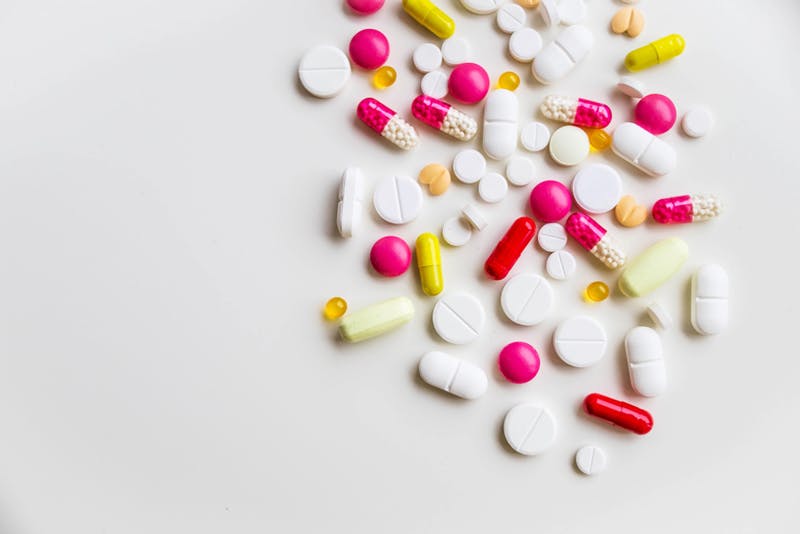 A selection of tablets and capsules on a surface