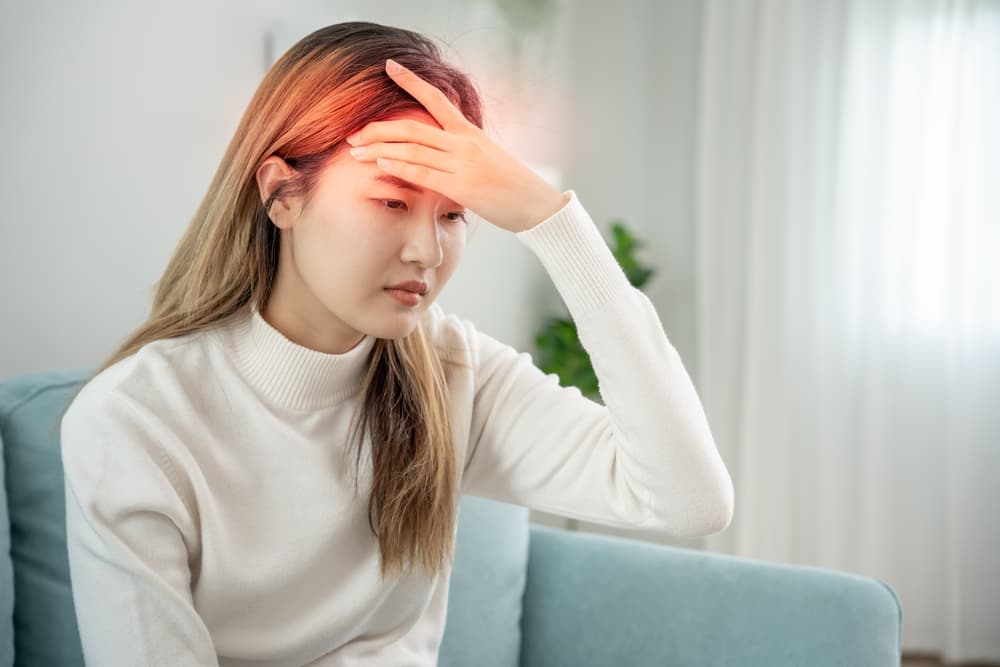 A lady experiencing a migraine